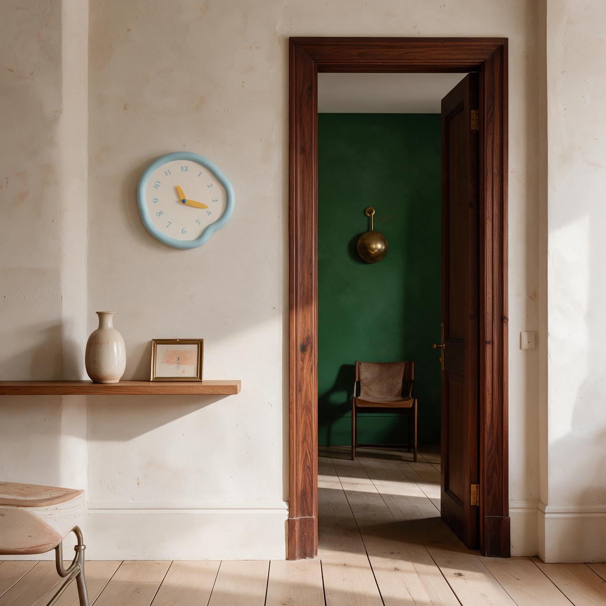 Ondara clock in baby blue beside a doorway shelf