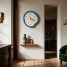 Ondara clock in blue beside a doorway shelf