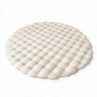 Nerja round bubble rug in beige on a white background