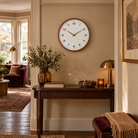 Biescas Round Wood Frame Silent Wall Clock for Kitchens and Living Rooms, Walnut Brown, in the room