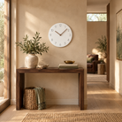 Caravaca Matte Round Silent Wall Clock with Wood Hands for Living Rooms, White, in the room